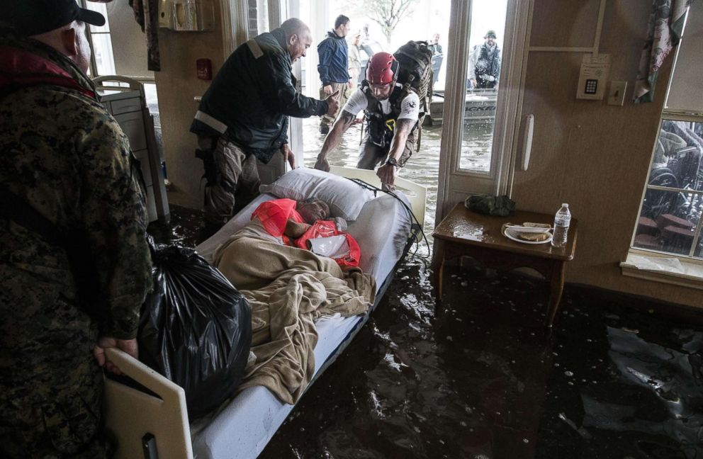PHOTO: Rescuers and volunteers help evacuate the Gulf Health Care Center which flooded, Aug. 30, 2017 in Port Arthur, Texas. 