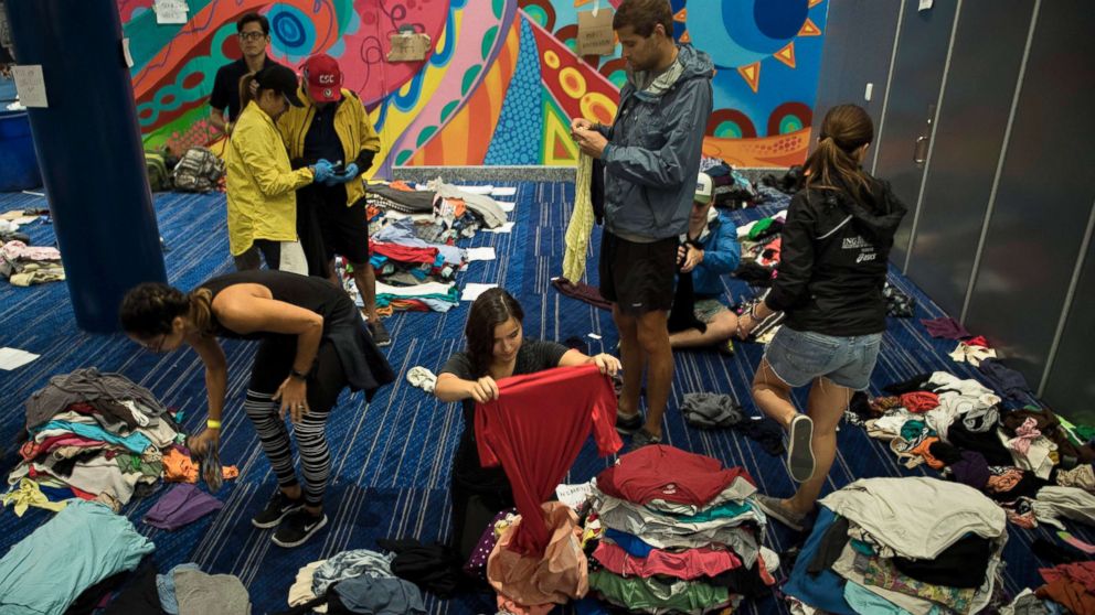 PHOTO: Volunteers sort through donated clothing at a shelter in the George R. Brown Convention Center during the aftermath of Hurricane Harvey, Aug. 28, 2017, in Houston.