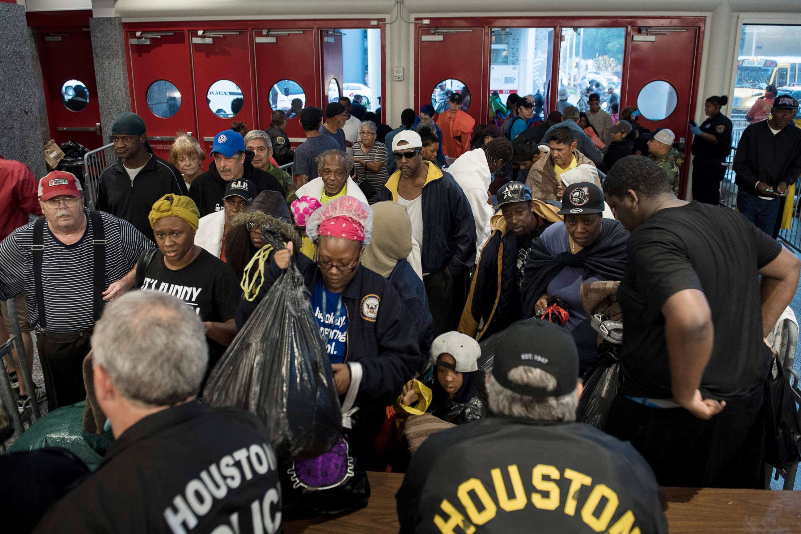 PHOTO: People wait to be checked by police before entering a shelter in the George R. Brown Convention Center during the aftermath of Hurricane Harvey, Aug. 28, 2017, in Houston.