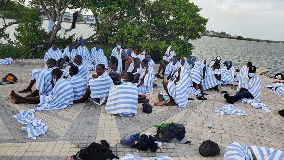 PHOTO: This photo provided by the United States Border Patrol shows Haitian migrants on shore wrapped in towels after a boat ran aground in the Florida Keys off Key Largo, Fla., on March 6, 2022.