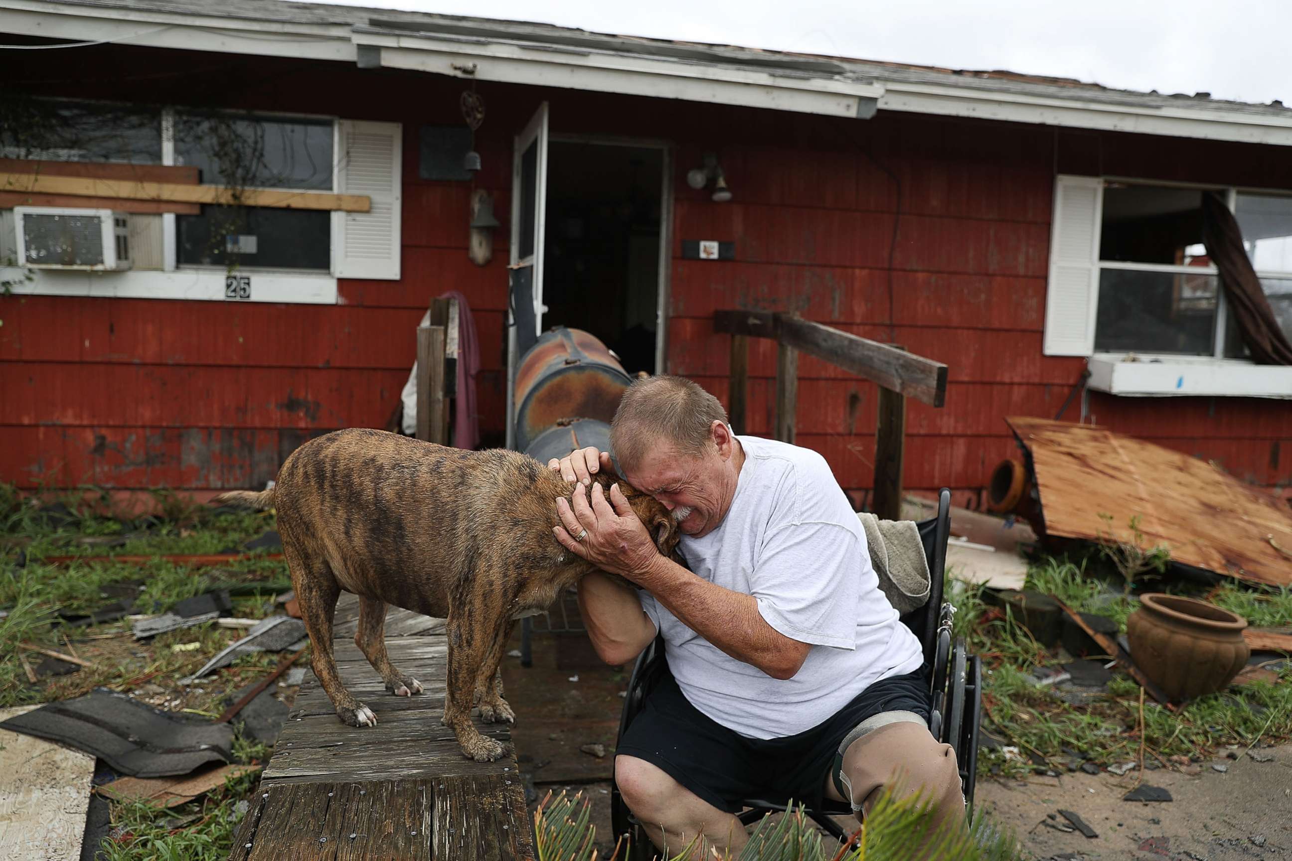 PHOTO: Steve Culver cries with his dog Otis as he talks about what he said was the, "most terrifying event in his life," when Hurricane Harvey blew in and destroyed most of his home while he and his wife took shelter, Aug. 26, 2017, in Rockport, Texas. 