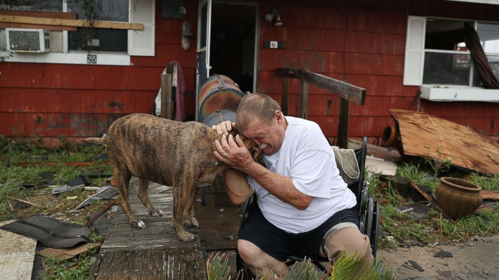 PHOTO: Steve Culver cries with his dog Otis as he talks about what he said was the, "most terrifying event in his life," when Hurricane Harvey blew in and destroyed most of his home while he and his wife took shelter, Aug. 26, 2017, in Rockport, Texas. 