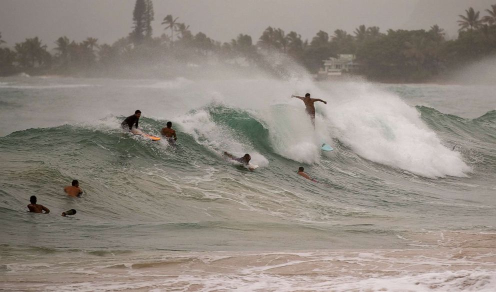 PHOTO: Surfers take on large waves generated by Hurricane Douglas at Laie Beach Park, Sunday, July 26, 2020, in Laie, Hawaii.