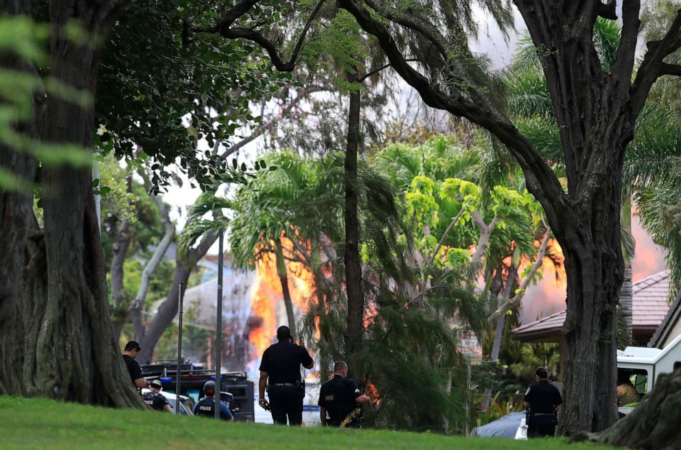 PHOTO: Honolulu police watch a house fire after a shooting and domestic incident at a residence on Hibiscus Road near Diamond Head, Jan. 19, 2020, in Honolulu.