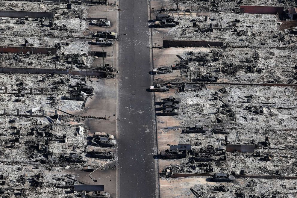 PHOTO: Burned cars sit in front of homes destroyed by a wildfire on Aug. 11, 2023, in Lahaina, Hawaii.