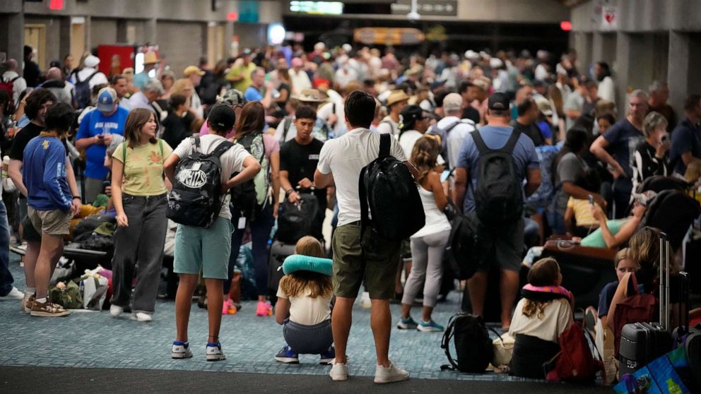 PHOTO: People gather at the Kahului Airport while waiting for flights Aug. 9, 2023, in Kahului, Hawaii.