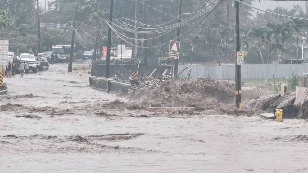PHOTO: Floodwaters stream down a street in Hauula, Hawaii, U.S. March 9, 2021, in this still image obtained from a social media video. 