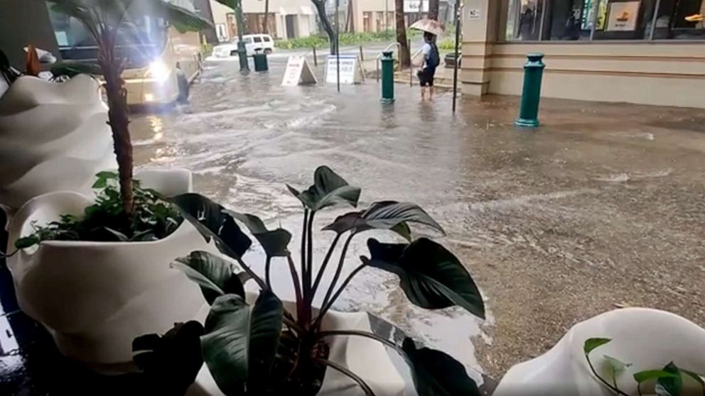 PHOTO: In this screen grab made from social media video, Dec. 5, 2021, a street in Waikiki, Hawaii is flooded following heavy rains.