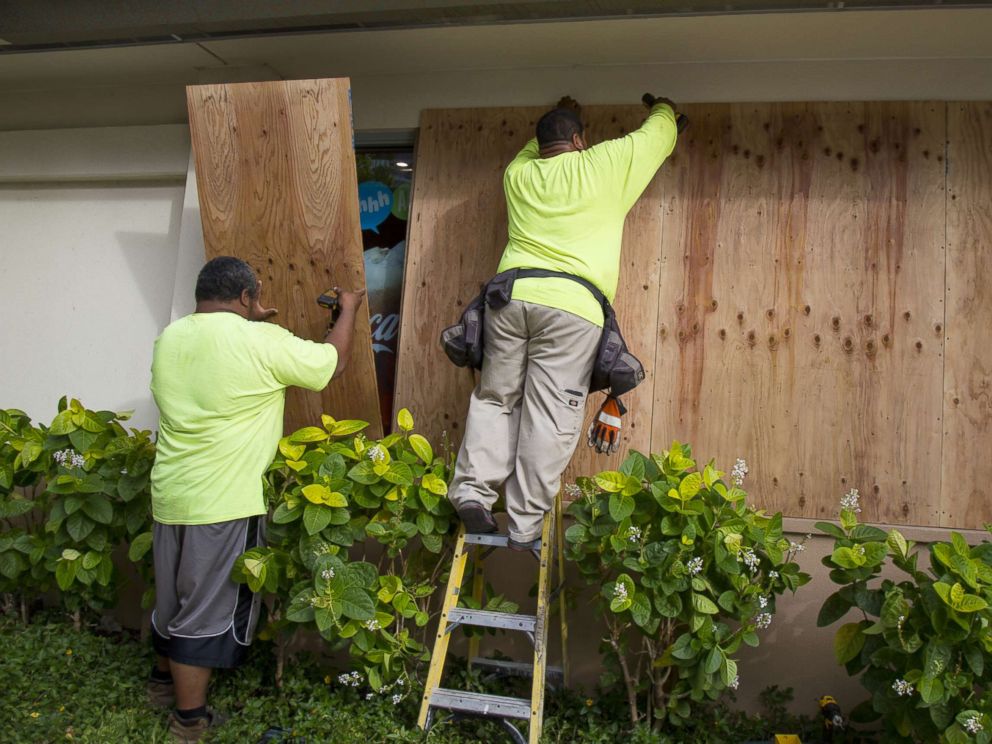 PHOTO: Yamasaki Construction workers, Talbot Khakai, left, and David Halafihi board up McDonalds multiple plate glass windows in preparation for Hurricane Lane on Aug. 22, 2018 in Honolulu.