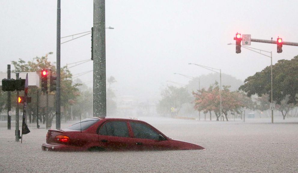 PHOTO: A car is stuck partially submerged in floodwaters from Hurricane Lane rainfall on the Big Island, Aug. 23, 2018, in Hilo, Hawaii.