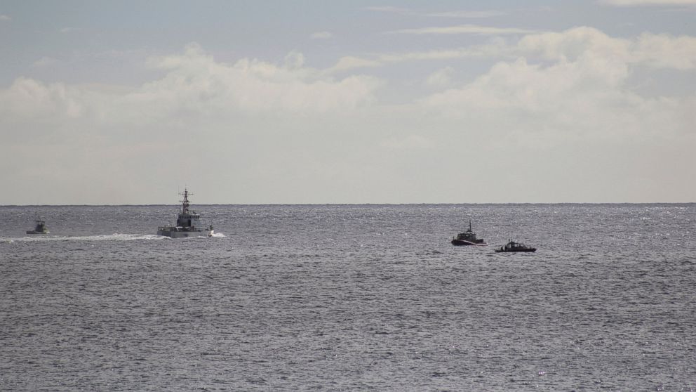 A U.S. Coast Guard vessel and other rescue boats respond to a plane crash off Honolulu, Wednesday, Dec. 12, 2018. Federal Aviation Administration spokesman Ian Gregor said a Hawker Hunter jet went down in the ocean around 2:25 p.m.