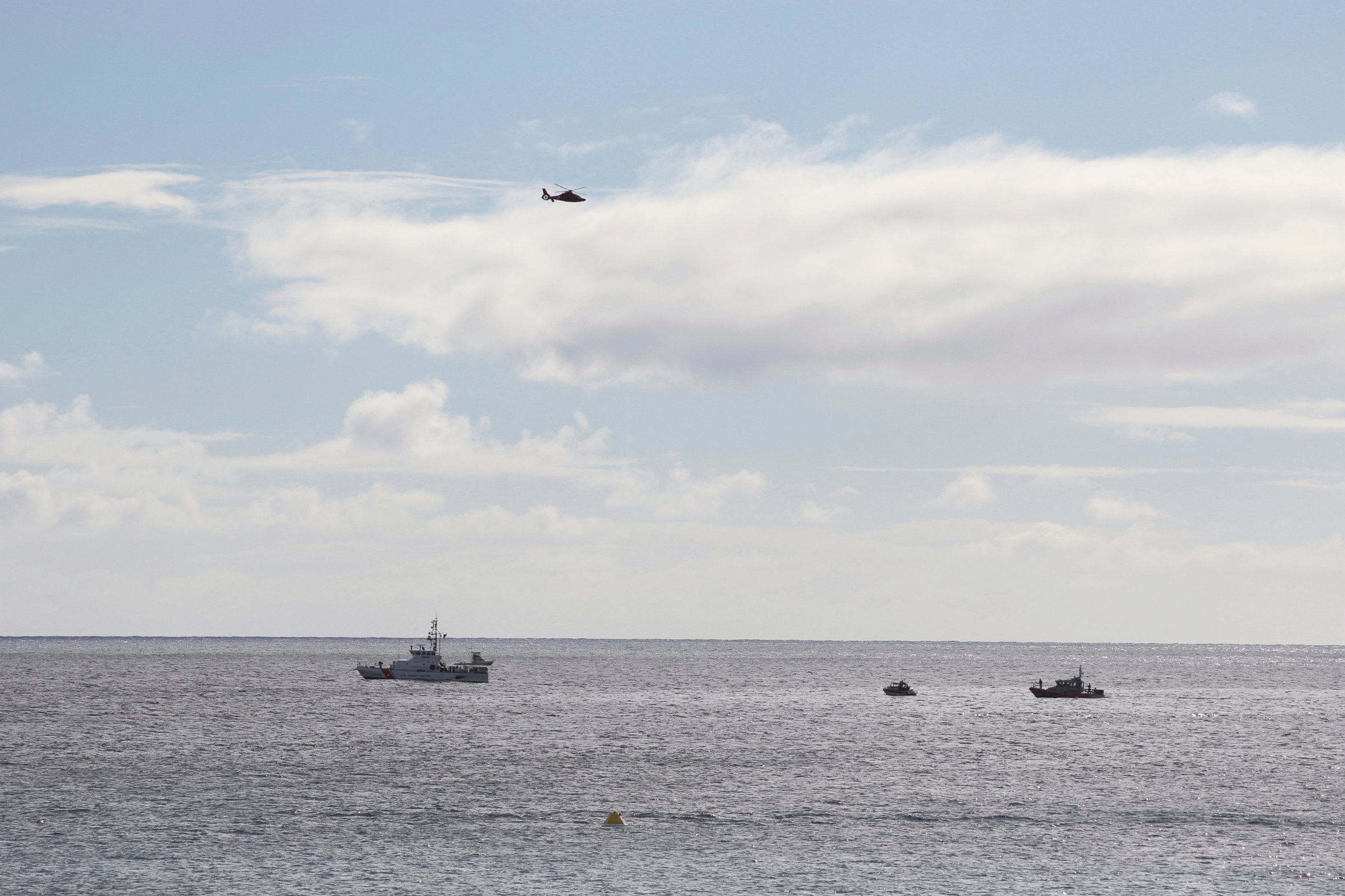 PHOTO: A U.S. Coast Guard vessel and other rescue boats respond to a plane crash off Honolulu, Wednesday, Dec. 12, 2018. Federal Aviation Administration spokesman Ian Gregor said a Hawker Hunter jet went down in the ocean around 2:25 p.m.
