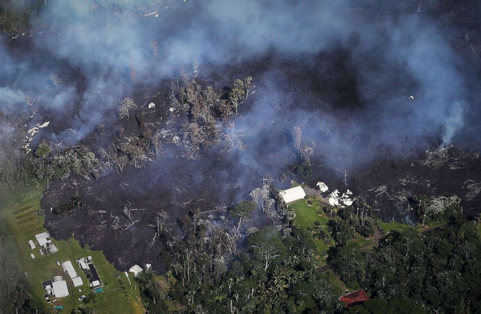 PHOTO: Lava from volcanic fissures overtakes structures and trees in the Leilani Estates neighborhood in the aftermath of eruptions from the the Kilauea volcano on Hawaii's Big Island on May 6, 2018 in Pahoa, Hawaii.