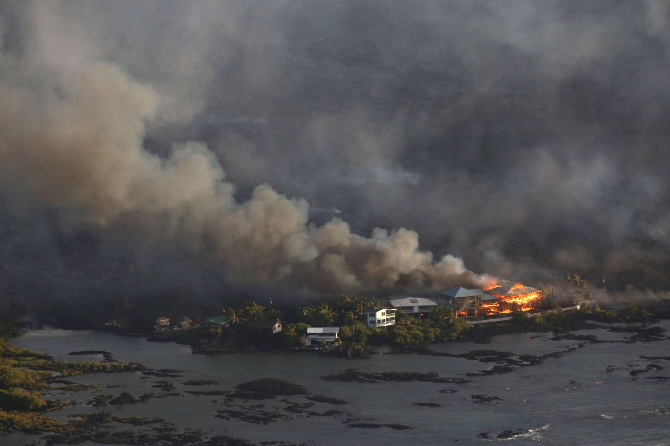 PHOTO: Lava destroys homes in the Kapoho area, east of Pahoa, during ongoing eruptions of the Kilauea Volcano in Hawaii, June 5, 2018.