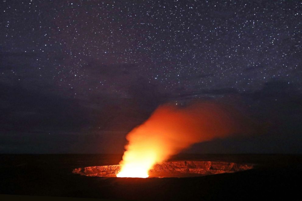 PHOTO: Stars shine above as a plume rises from the Halemaumau crater, illuminated by glow from the crater's lava lake, within the Kilauea volcano summit at the Hawaii Volcanoes National Park, May 9, 2018, in Hawaii Volcanoes National Park, Hawaii.