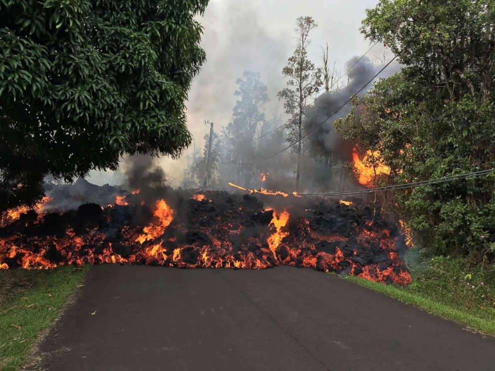 PHOTO: This image obtained May 9, 2018, released by the US Geological Survey shows a lava flow moving on Makamae Street in Leilani Estates at 09:32 am local time, on May 6, 2018 in Leilani Estates, Hawaii.