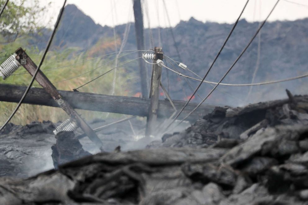 PHOTO: Utility poles and power lines sit destroyed in the Kilauea lava flow on Pohoiki Road near Pahoa, Hawaii, May 29, 2018.