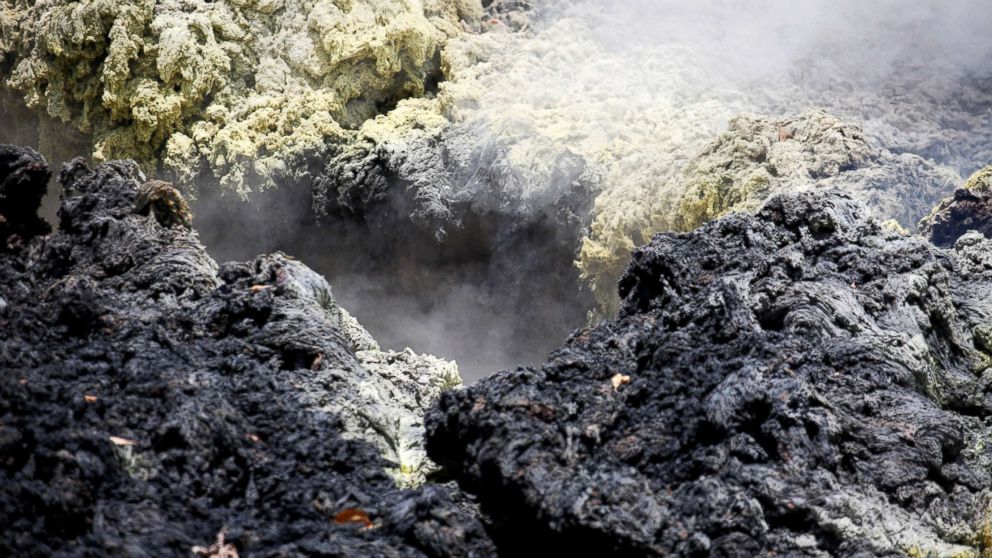 Volcanic gases rise from a fissure in the Leilani Estates subdivision during ongoing eruptions of the Kilauea Volcano in Hawaii, May 14, 2018.