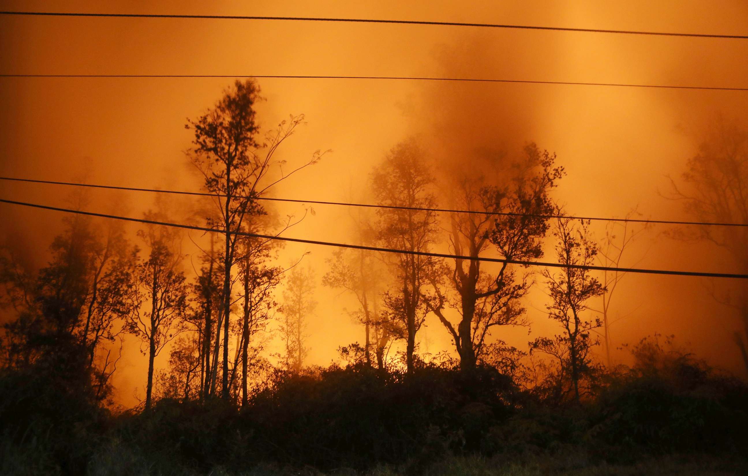 PHOTO: Lava illuminates volcanic gases from the Kilauea volcano at fissure 13 on Hawaii's Big Island, May 16, 2018, in Pahoa, Hawaii.