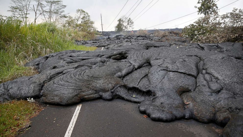 PHOTO: Lava covers Pohoiki Road near Pahoa, Hawaii, May 29, 2018.