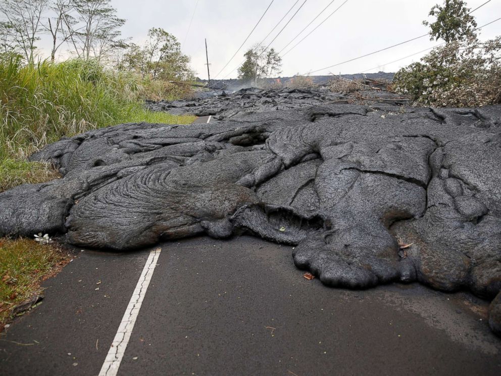 PHOTO: Lava covers Pohoiki Road near Pahoa, Hawaii, May 29, 2018.