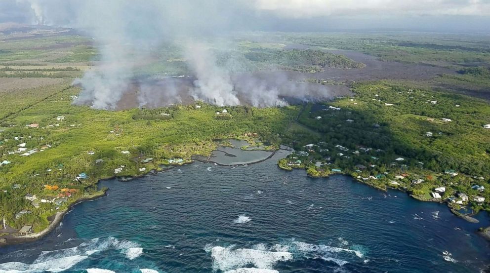 PHOTO: Fumes and lava flow from Kilauea Volcano on Hawaii's Big Island towards the ocean in an image taken from a helicopter on June 3, 2018.