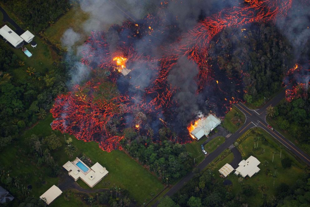 PHOTO: Molten flows into the Leilani Estate subdivision, near Pahoa, Hawaii, May 6, 2018. A local state of emergency was declared after Mount Kilauea erupted near residential areas, forcing mandatory evacuations.