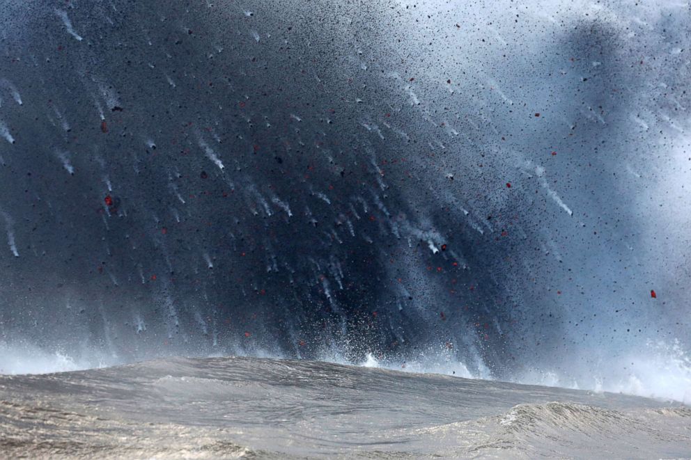 PHOTO: Lava flows into the Pacific Ocean, southeast of Pahoa, during ongoing eruptions of the Kilauea Volcano in Hawaii, May 20, 2018.