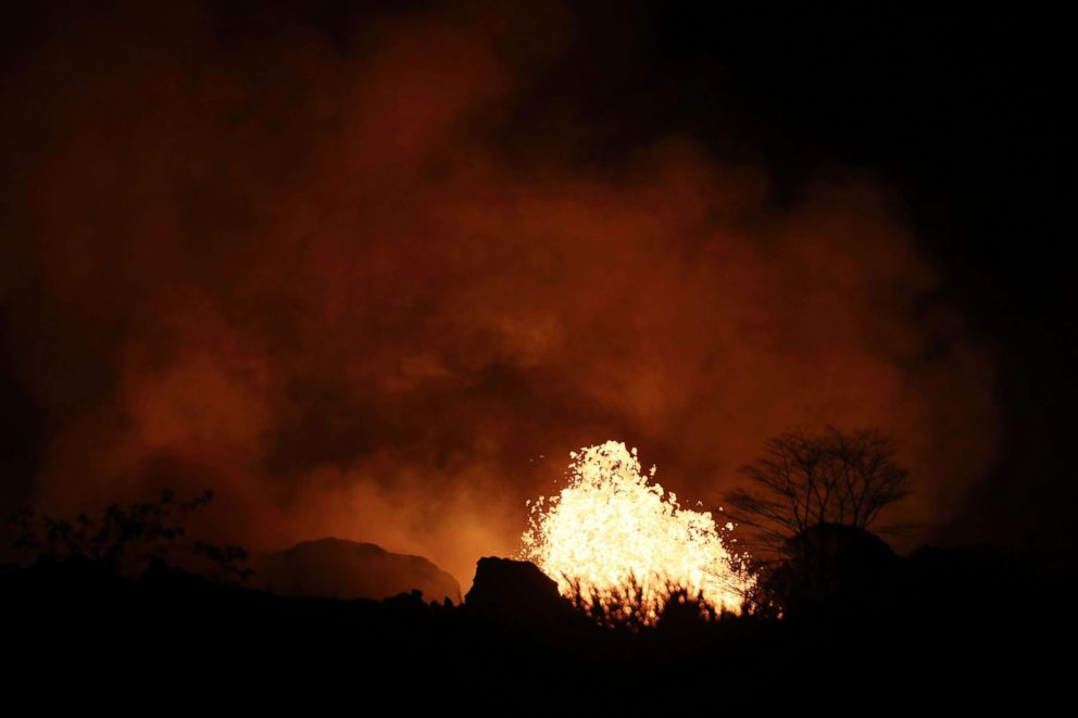 PHOTO: Lava erupts from a Kilauea volcano fissure on Hawaii's Big Island, May 22, 2018 in Kapoho, Hawaii. 