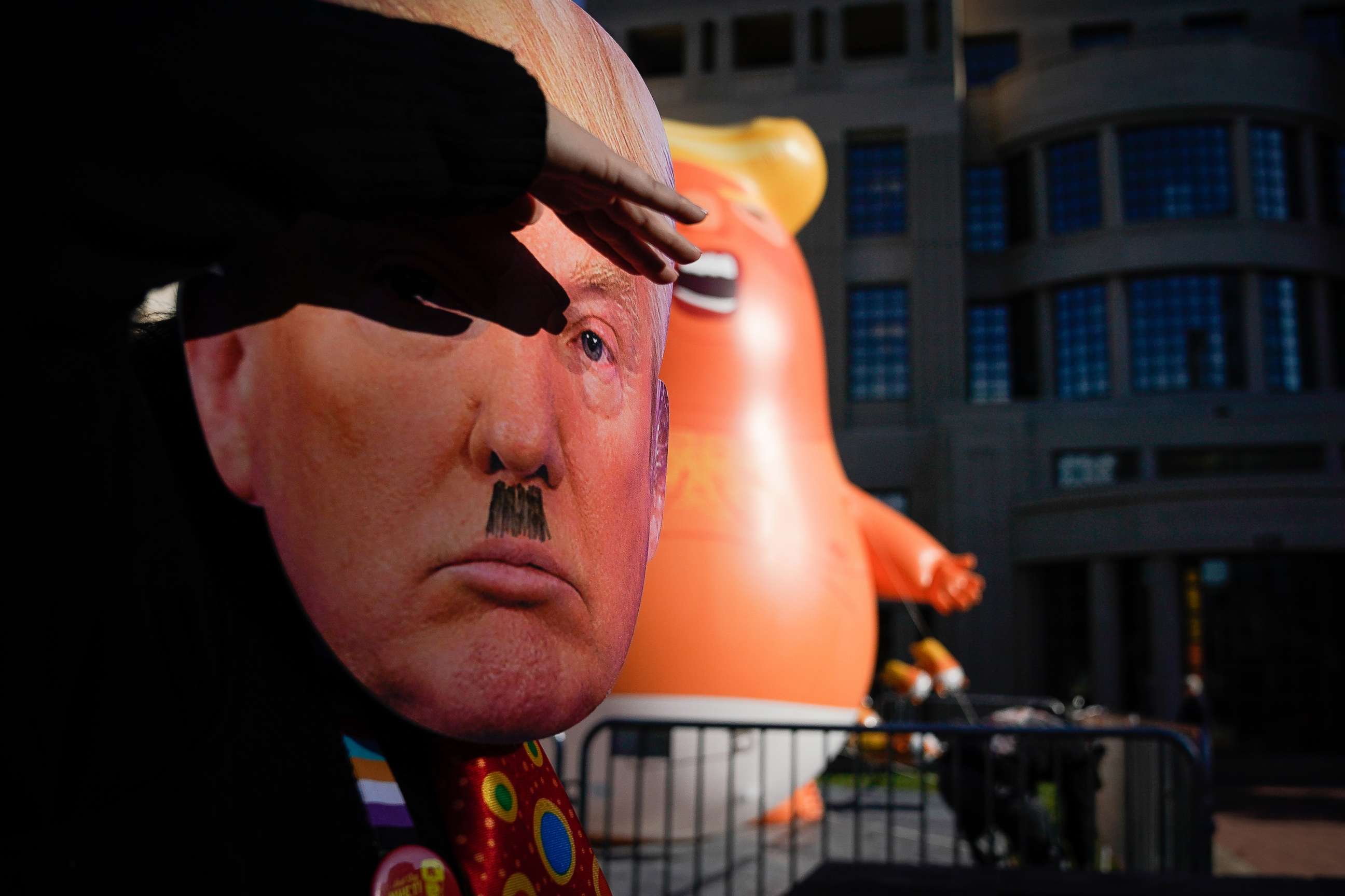 PHOTO: A protester wearing a mask dances near a Baby Trump balloon last week in front of the courthouse on November 4, 2019 in Lexington, Kentucky. (Photo by Bryan Woolston/Getty Images)
