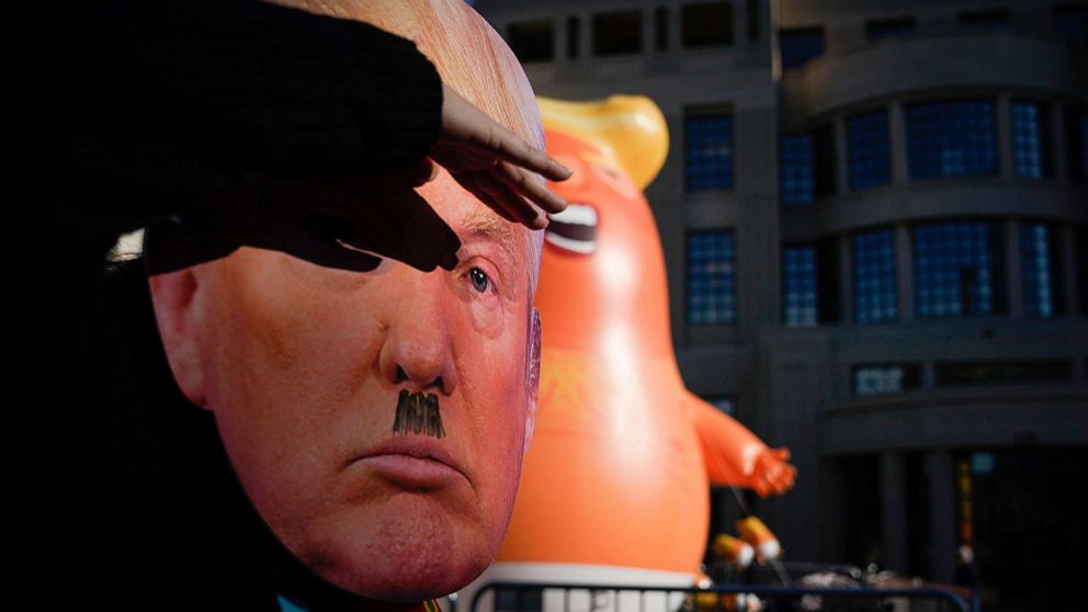 PHOTO: A protester wearing a mask dances near a Baby Trump balloon last week in front of the courthouse on November 4, 2019 in Lexington, Kentucky. (Photo by Bryan Woolston/Getty Images)