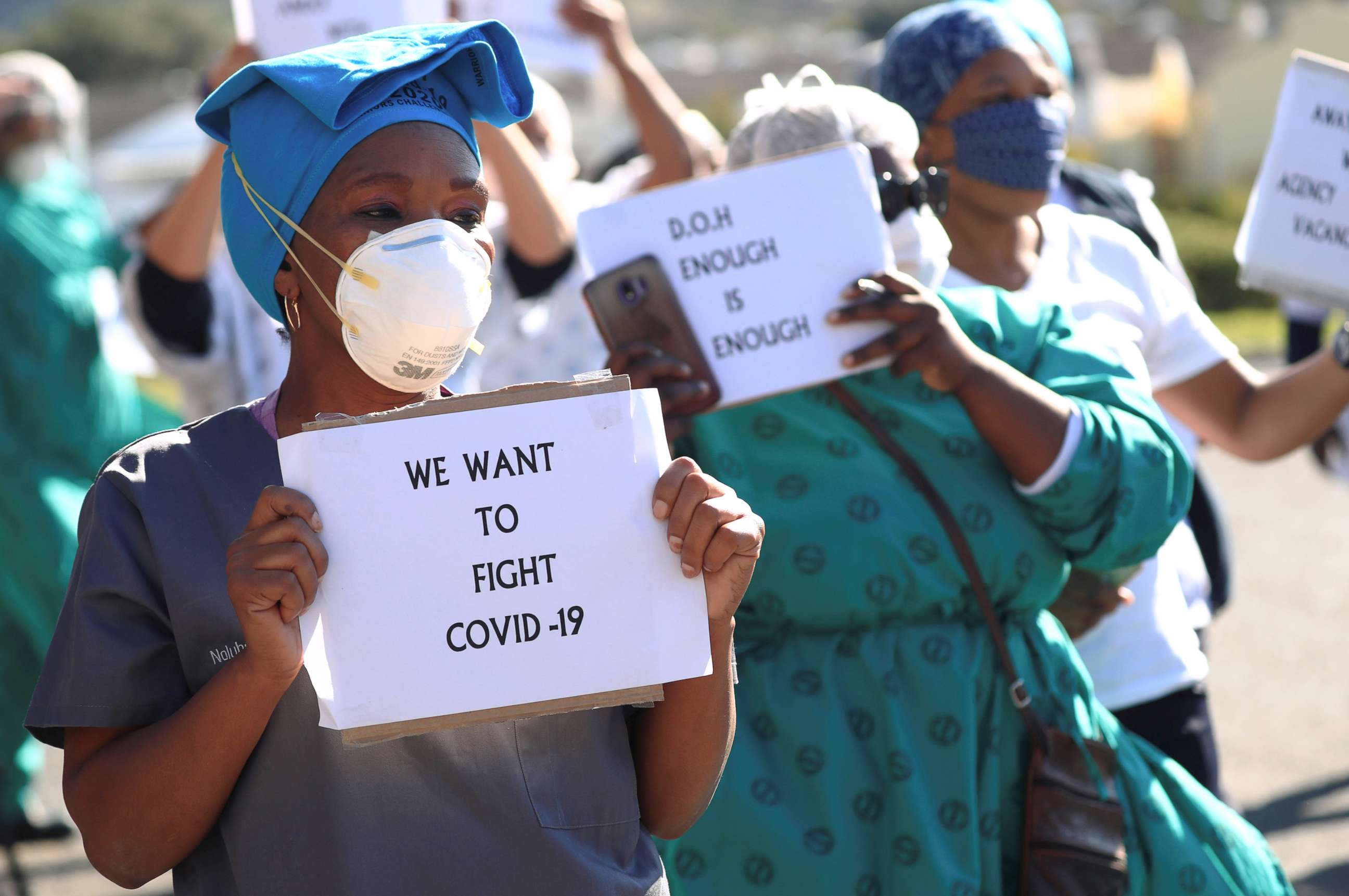 PHOTO: Health care workers holding signs, protest over the lack of personal protective equipment (PPE) during the coronavirus outbreak, outside a hospital in Cape Town, South Africa, June 19, 2020.