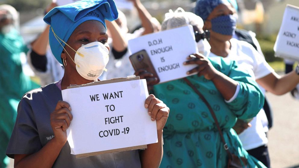 PHOTO: Health care workers holding signs, protest over the lack of personal protective equipment (PPE) during the coronavirus outbreak, outside a hospital in Cape Town, South Africa, June 19, 2020.