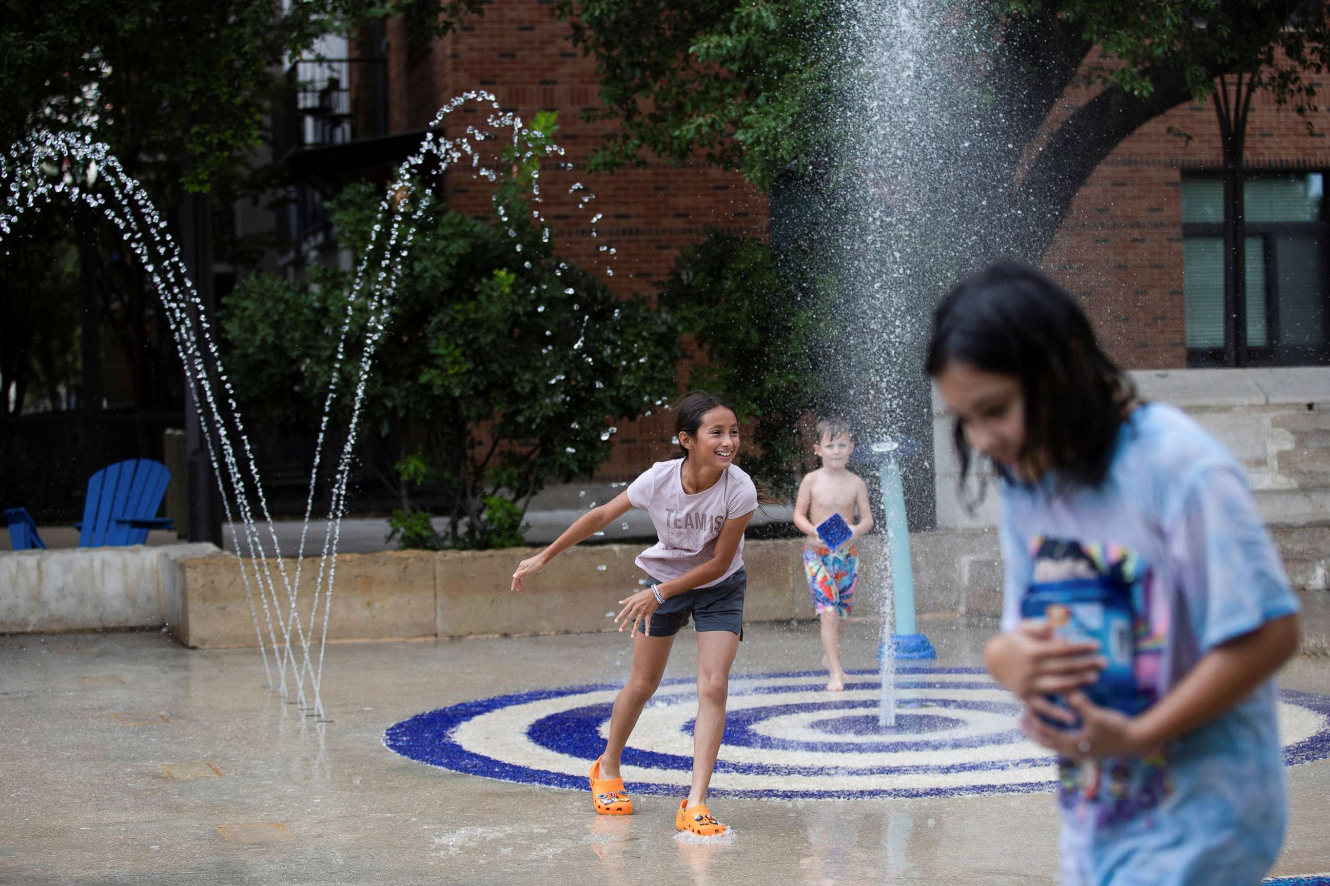 PHOTO: Kids play in a splash pad at Hemisfair Park as temperatures reached 93°F in San Antonio, Texas, June 28, 2022. 
