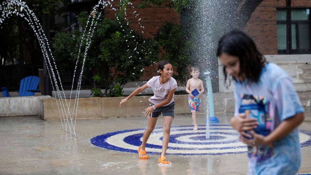 PHOTO: Kids play in a splash pad at Hemisfair Park as temperatures reached 93°F in San Antonio, Texas, June 28, 2022. 