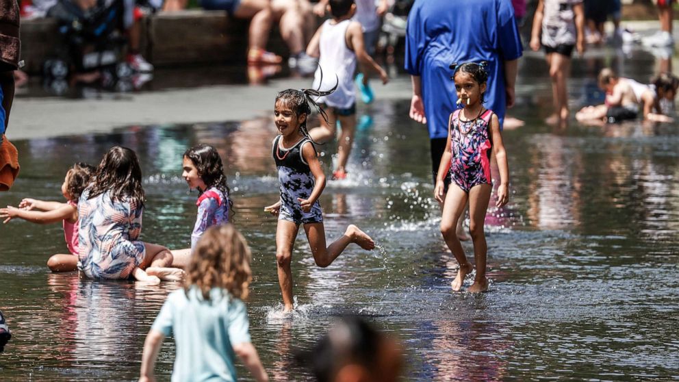 PHOTO: People seek relief from a dangerous heat wave at the Crown Fountain and wading pool in Chicago, June 15, 2022. 