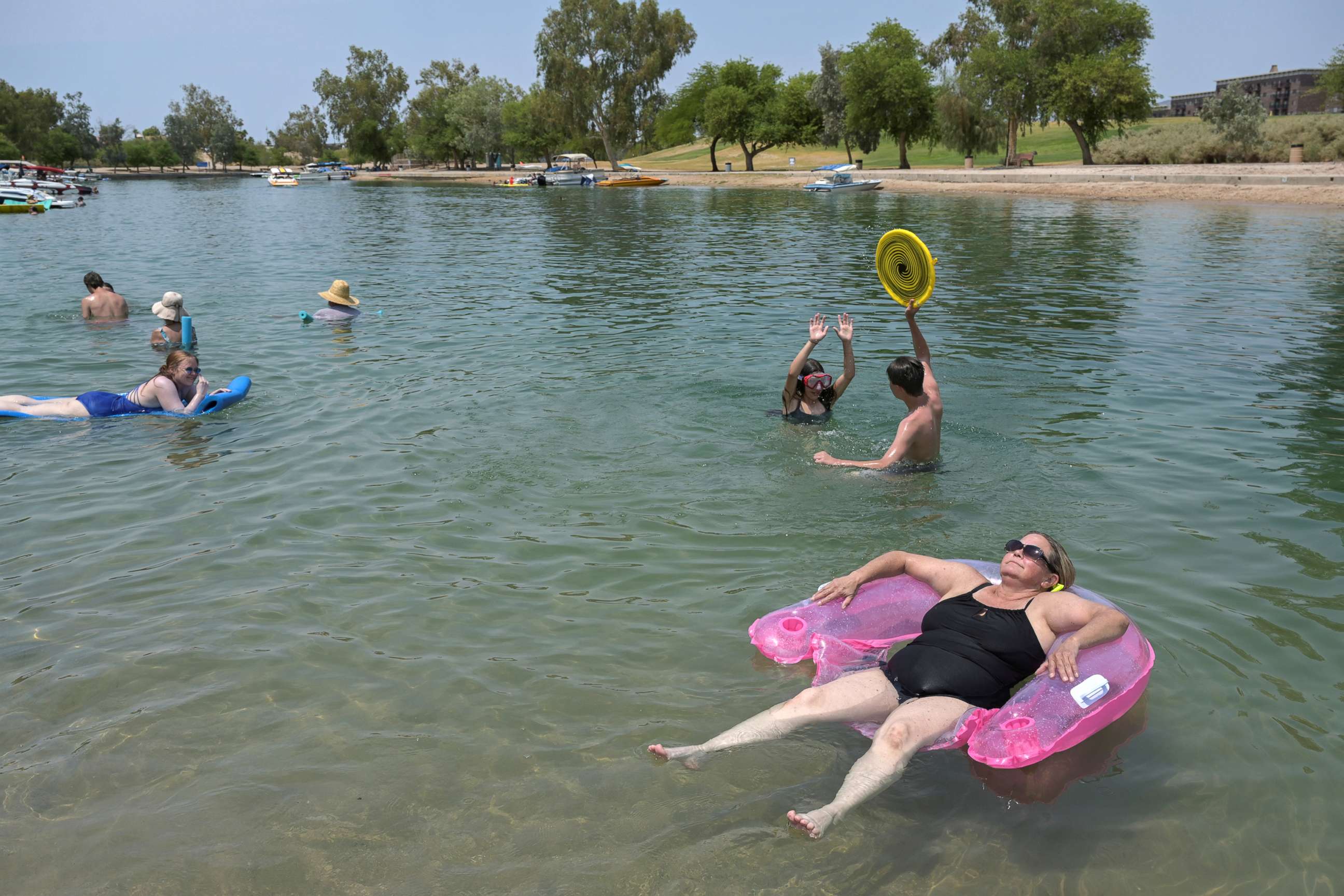 PHOTO: Tricia Watts, right, uses a floaty as she cool off in the water during a heat wave in Lake Havasu, Ariz., June 15, 2021.