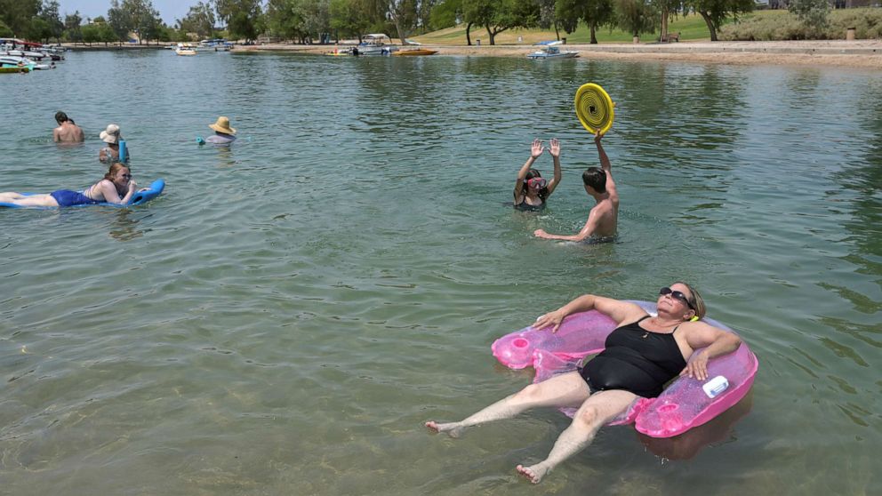PHOTO: Tricia Watts, right, uses a floaty as she cool off in the water during a heat wave in Lake Havasu, Ariz., June 15, 2021.
