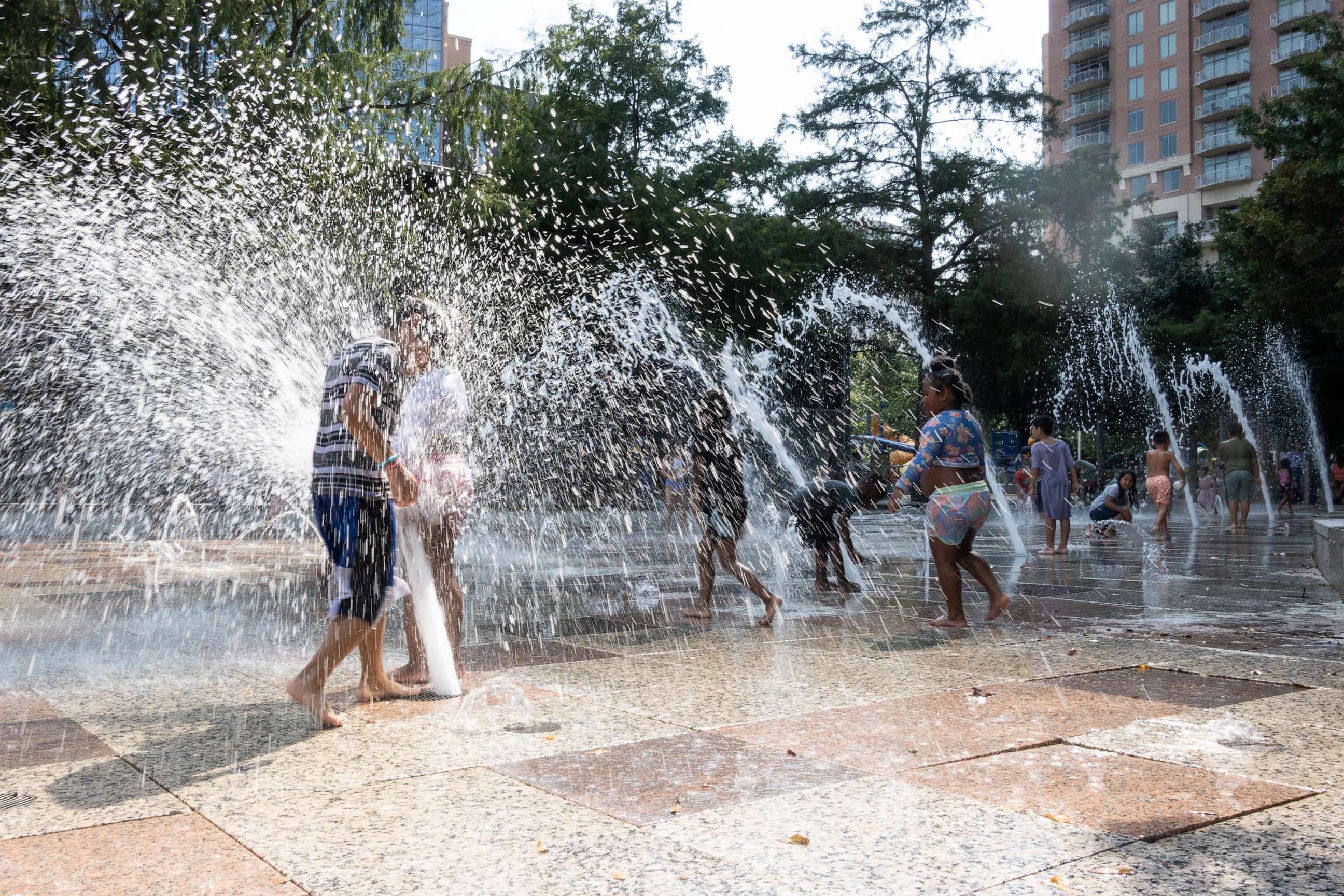 PHOTO: Children play and cool off at a splash park in downtown Houston, Texas, on June 15, 2023.