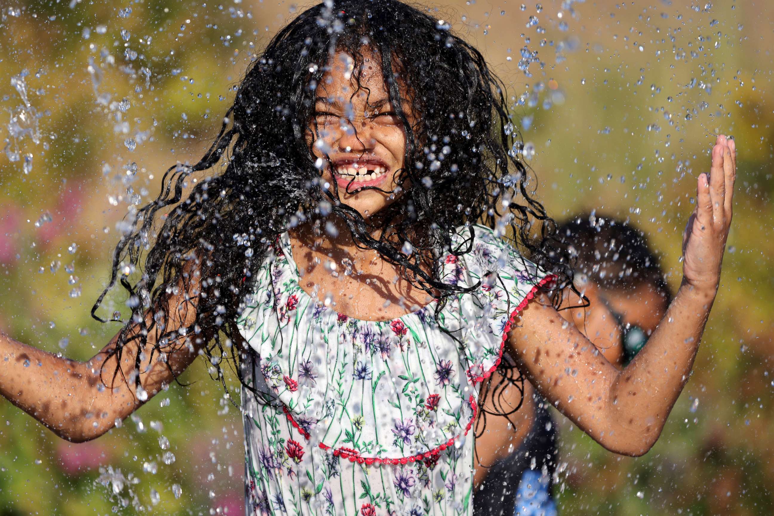 PHOTO: A child plays in a spray park at Jefferson Park during a heat wave in Seattle, June 27, 2021.