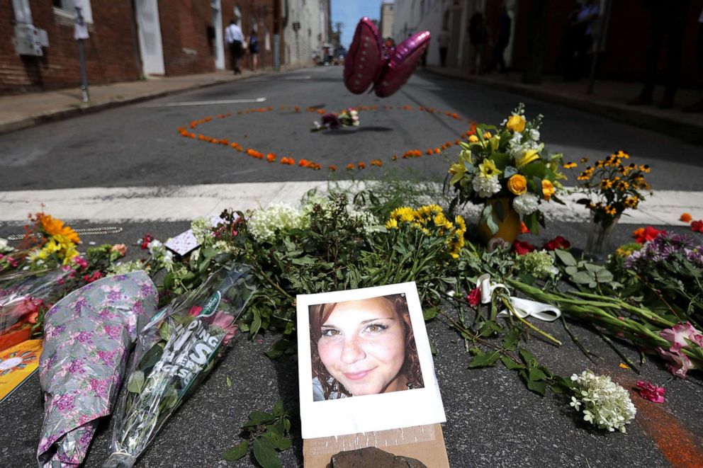 PHOTO: Flowers surround a photo of Heather Heyer, who was killed when a car plowed into a crowd of people protesting against the white supremacist Unite the Right rally, Aug. 13, 2017, in Charlottesville, Virginia.