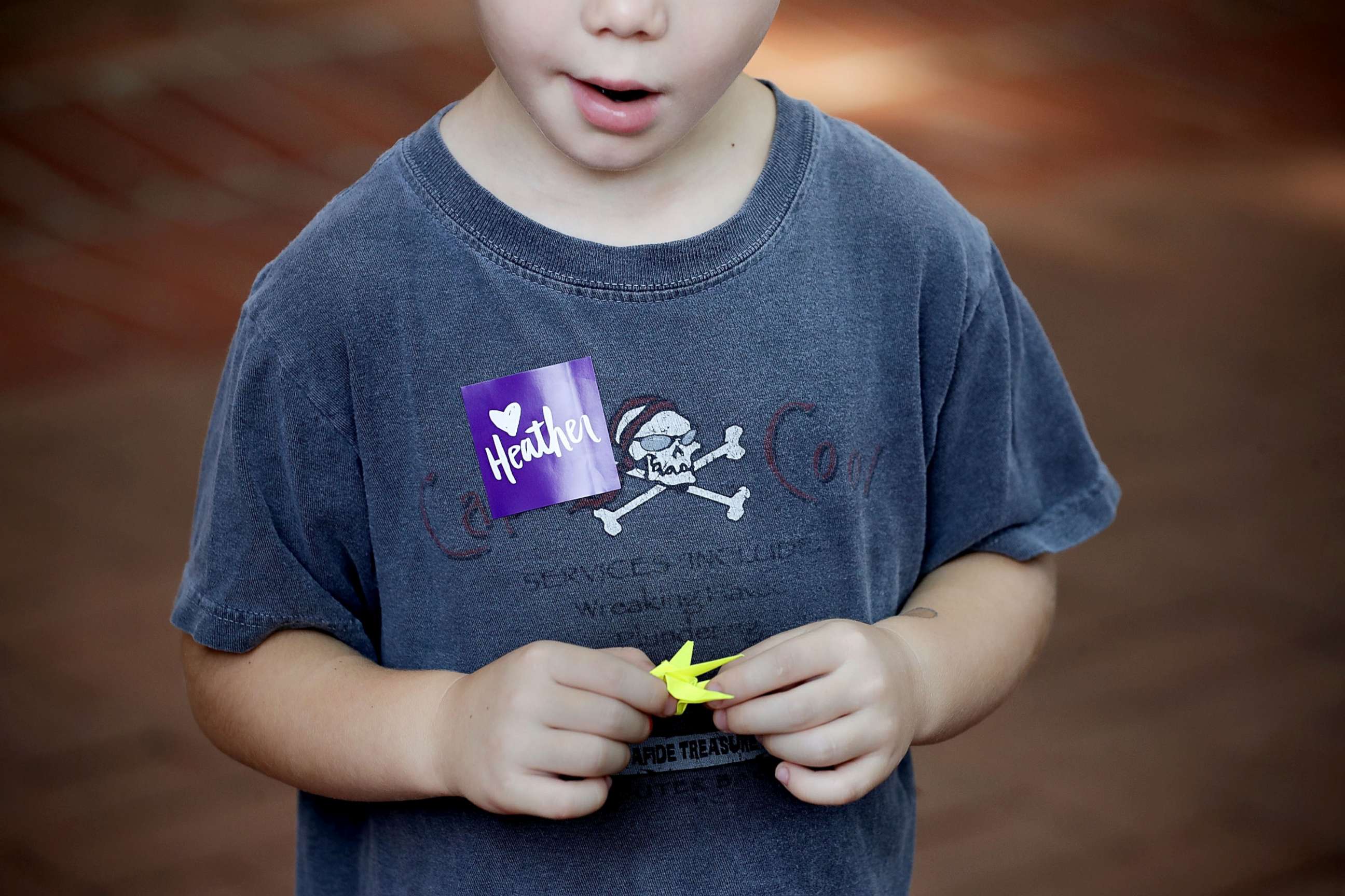 PHOTO: A boy holds a paper crane while waiting in line for the memorial service for Heather Heyer, who was killed when a car slammed into a crowd of people protesting against a white supremacist rally, Aug. 16, 2017 in Charlottesville, Va.