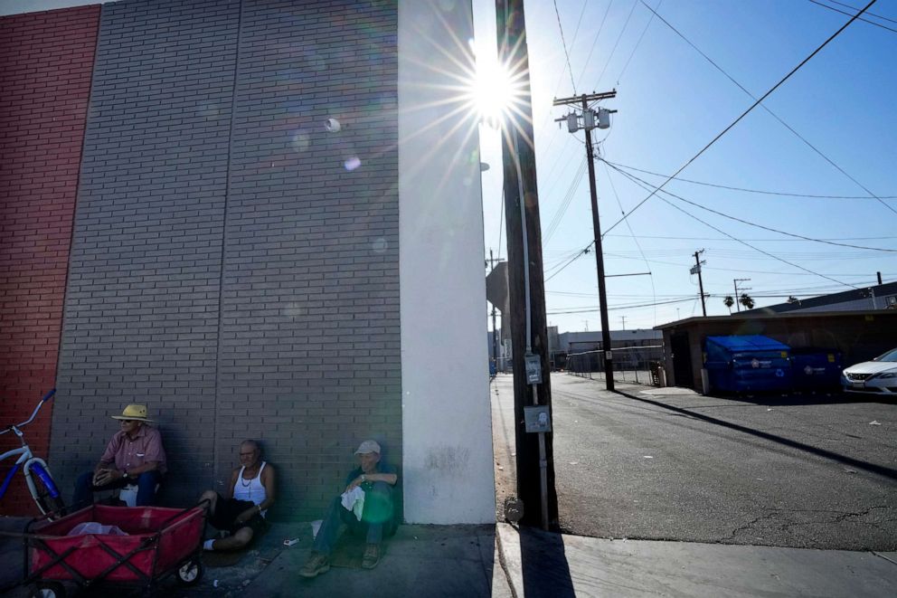PHOTO: Men sit in the shade amid extreme heat, July 19, 2023, in Calexico, Calif.