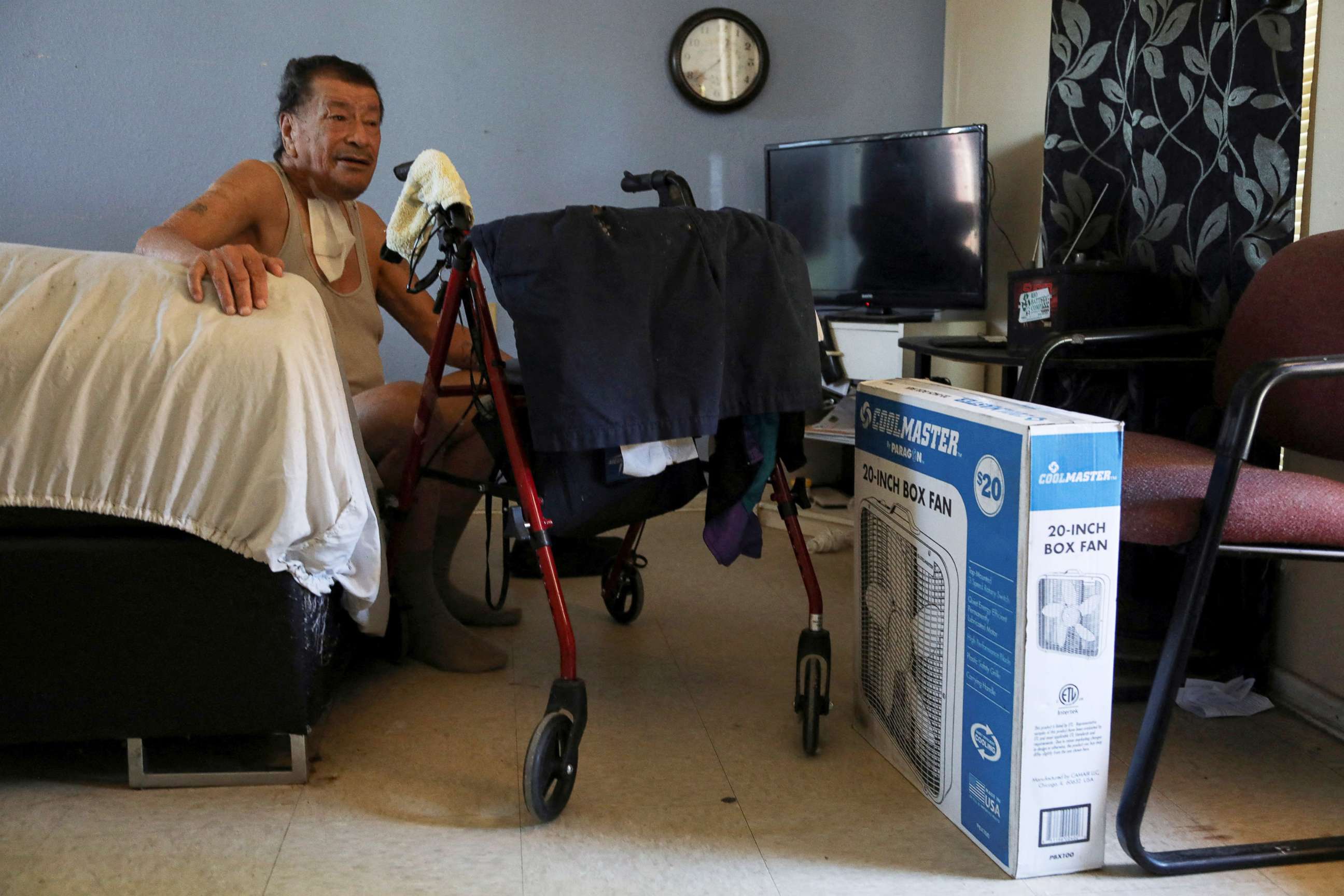 PHOTO: Ramiro Cervantes sits next to a newly donated fan in his apartment at Col. George Cisneros Apartments, a senior apartment complex, in San Antonio, Texas, July 11, 2022.