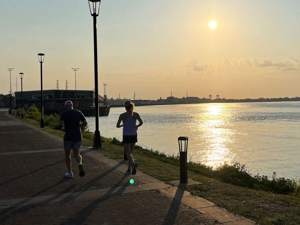 PHOTO: Local joggers beat the heat with an early morning run along the Mississippi River in New Orleans., June 23, 2022.