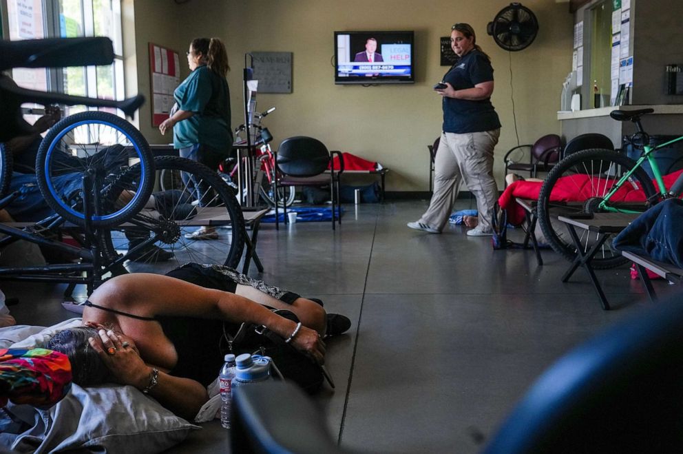 PHOTO: Mary G., left, rests inside a heat relief station at the Mesa Corps Community Center in Mesa, Ariz,  June 16, 2022.