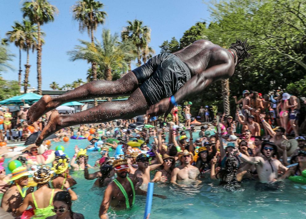 PHOTO: A man gets airborne on his way into the pool in Palm Springs, Calif., June 11, 2022.