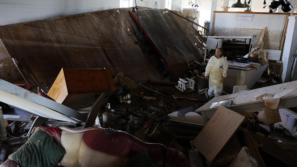 PHOTO: Brit Oie, an artist originally from Norway, searches through damage at Riverside Studios in the aftermath of flooding of the French Broad River caused by Tropical Storm Helene in Asheville, NC, Oct. 2, 2024.