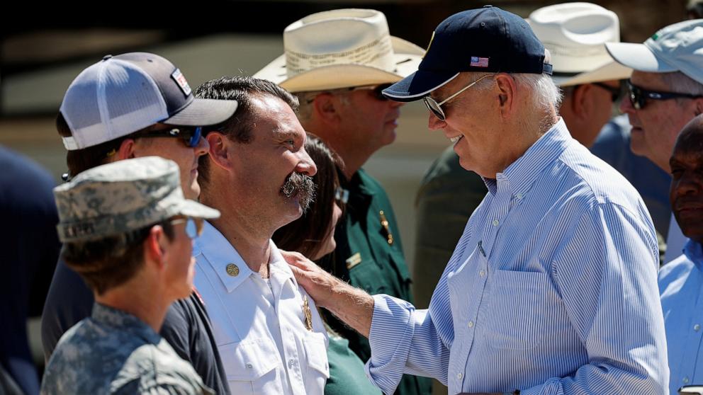 PHOTO: President Joe Biden speaks with a first responder, as he visits storm-damaged areas in the wake of Hurricane Helene, in Keaton Beach, Florida, October 3, 2024. 