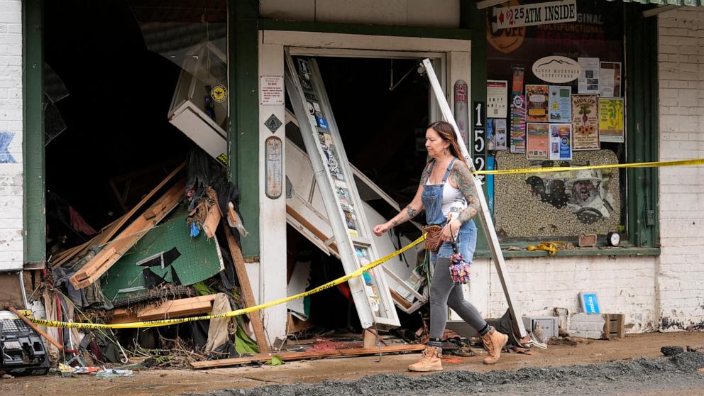 PHOTO: A person walks past a building heavily damaged during Hurricane Helene, Oct. 1, 2024, in Hot Springs, N.C. 